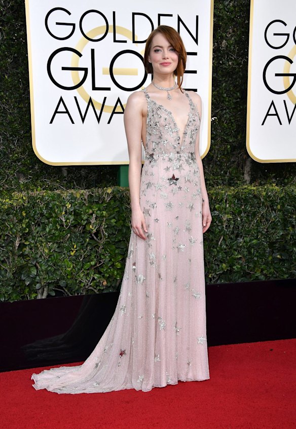 Actress Emma Stone proves once again she is one of the best-dress actresses on red carpets with her light-pink with silver stars Valentino gown.
