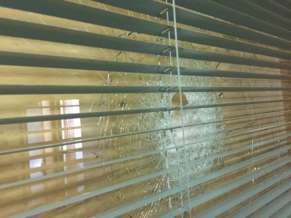 A smashed window at a Canberra synagogue.