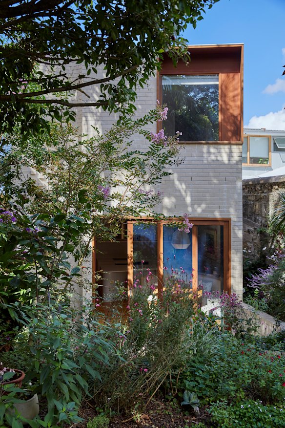 Opening to a courtyard, the brick addition has a kitchen, dining area, laundry and bathroom on the ground level and a spacious bedroom with en suite upstairs.