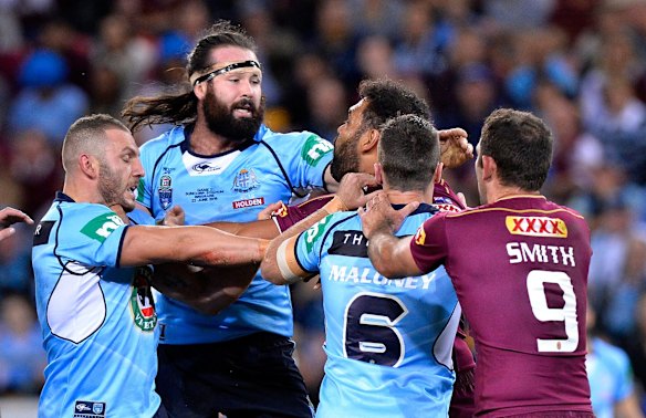 Aaron Woods of the Blues and Sam Thaiday of the Maroons are involved in a push and shove