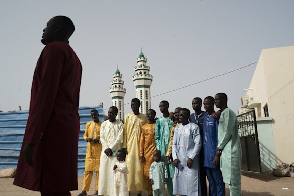Senegalese youth have their picture taken after attending the Eid al-Adha prayer in Dakar, Senegal.
