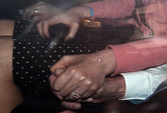 Wendi Deng, wife of News Corporation Chief Rupert Murdoch, holds his hand as they arrive back at his London home.