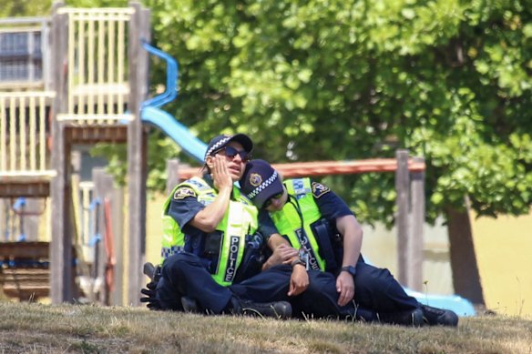 Police officers react after attending a jumping castle accident at Hillcrest Primary School.