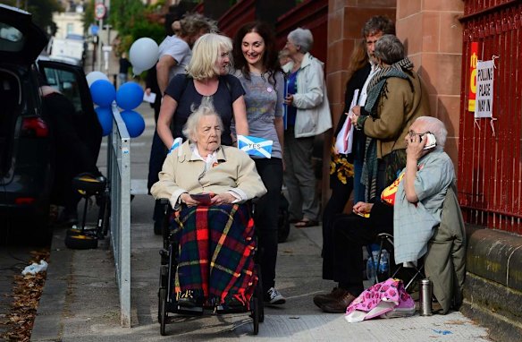 Voters come to Notre Dame Primary School polling station in Glasgow.