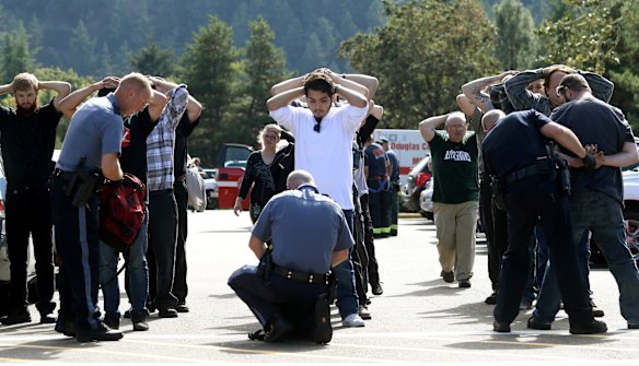Police search students outside Umpqua Community College in Roseburg, Oregon.