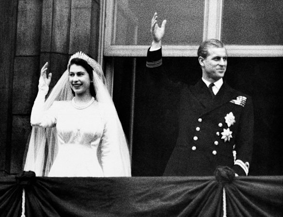 Princess Elizabeth and the Duke of Edinburgh wave to the crowds on their wedding day from the balcony of Buckingham Palace in London, November 20, 1947.