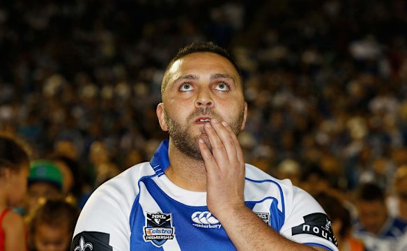 A Bulldogs fan reacts as he watches the NRL Final at Belmore Sports Ground.