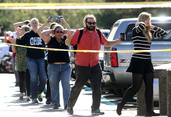 Students, staff and faculty members are evacuated from Umpqua Community College in Roseburg, Oregon. after a deadly shooting.