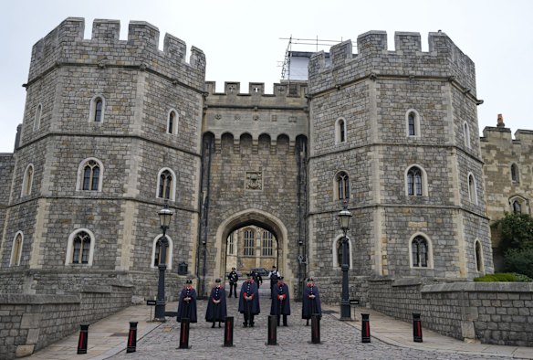 Wardens stand outside the gates of Windsor Castle in Windsor, England, Friday, Sept. 9, 2022.