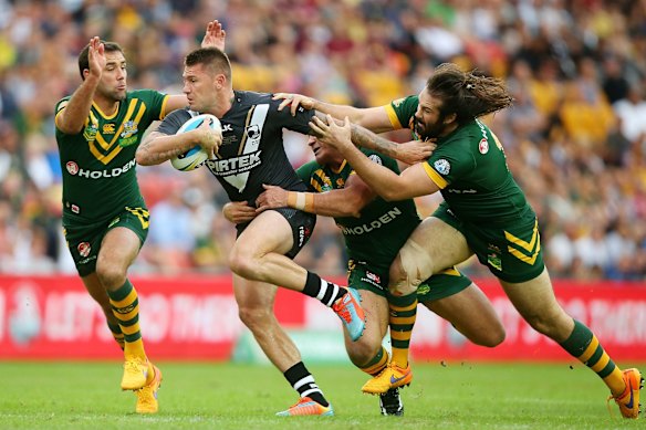 Shaun Kenny-Dowall of New Zealand runs the ball with a trio of Kangaroos in chase. 