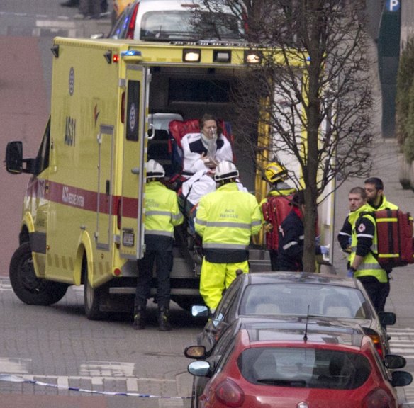 A woman is evacuated in an ambulance by emergency services after a explosion in a main metro station in Brussels.