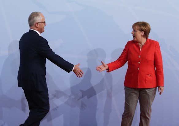 Australian Prime Minister Malcolm Turnbull is welcomed by Greman Chancellor Angela Merkel after Mr Turmbull arrived late because of a security lockdown in Hamburg, Germany.