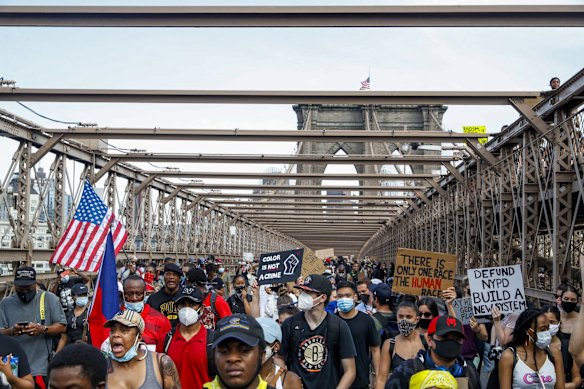 Protesters march on the Brooklyn Bridge after a rally in Cadman Plaza Park.