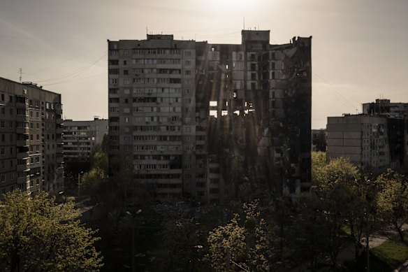 A building heavily damaged by multiple Russian bombardments stands near a front line in Kharkiv.
