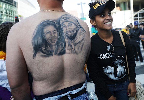 A man displays a Kobe and Gianna tattoo.
