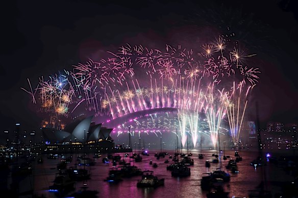 The New Years Eve Midnight fireworks light up the Sydney Harbour Bridge and Opera House.