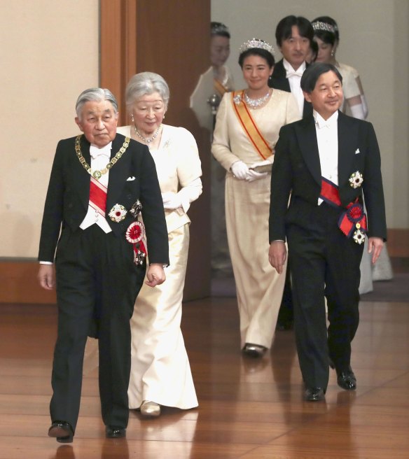 Japanese Emperor Akihito, left, and Empress Michiko, second from left, Crown Prince Naruhito, right, and Crown Princess Masako, second from right, arrive for an imperial ceremony on  New Year's Day at the Imperial Palace in Tokyo.