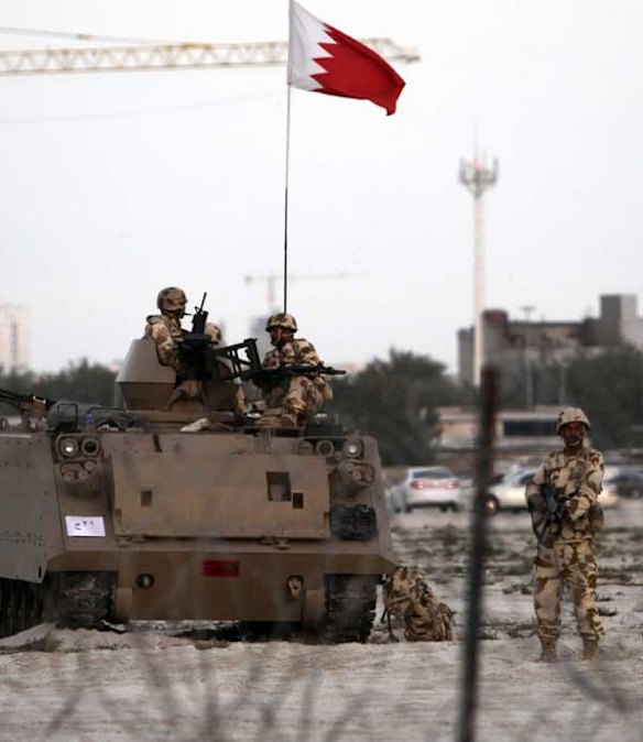 Bahraini soldiers stand guard near the Pearl roundabout in Manama, Bahrain.