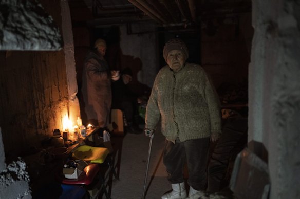 An elderly woman prepares to have lunch in the basement of a building that was used as housing for 400 people, since its apartments were used by Russian soldiers during the occupation of Bucha, on the outskirts of Kyiv.