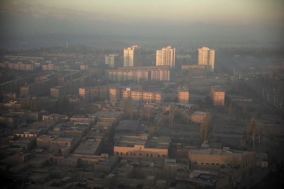Buildings stand shrouded in haze at sunrise in Kashgar, Xinjiang autonomous region, China.
