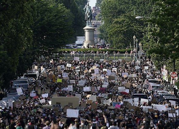 Hundreds of demonstrators march toward Lafayette Park and the White House on Tuesday in Washington DC.
