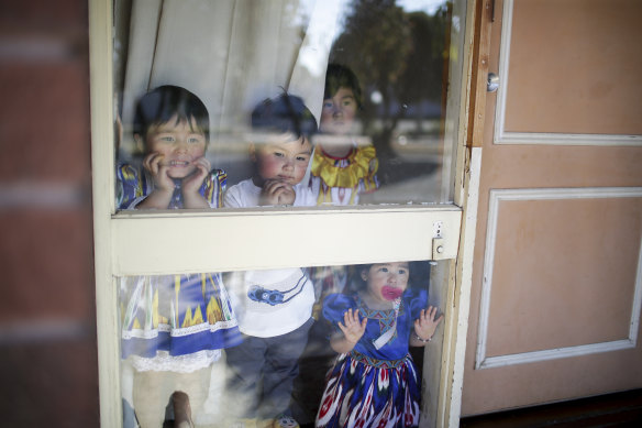 Uighur children Efruz, Abdukuddus, Elif and Melek watch as a car pulls into their driveway at their home in Adelaide.