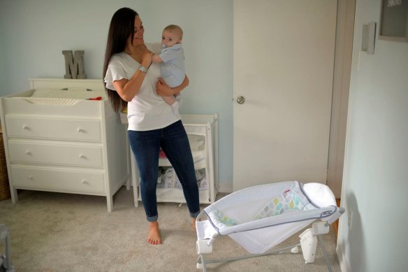 Miana Marie holds her four-month son, Mason, in his room in Alexandria, Virginia. She had used the Fisher-Price Rock ‘n Play sleeper for the child until the recall. 