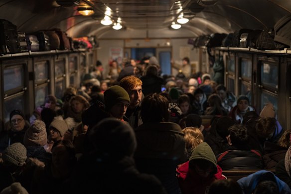 Displaced Ukrainians head from Lviv to Poland. Lviv's population has swelled as nearly 2.6 million people flee the country.