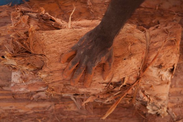 July 19th 2011, step 3 is to rewrap the remains in a paperbark parcel ,as human bones are finally reurned to their ancestral home in Gunbalanya for ceremonial reburial after over 60 years in the posession of the Smithsonian Institution after being collected during a combined Australian and American expedition to Arnhem Land in 1948.