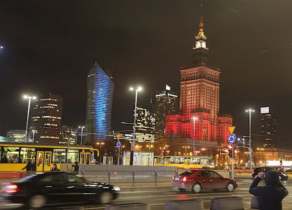 The Palace of Culture, right, the tallest building in the Polish capital, is lit in the colours of the Belgian flag in solidarity.