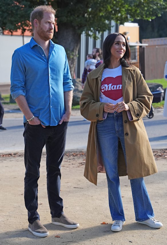 Prince Harry with Meghan, Duchess of Sussex, wearing the Lou coat from Friends With Frank, an Alliance of Mom’s fundraising T-shirt, Rolla’s jeans and Freda Salvador sneakers.