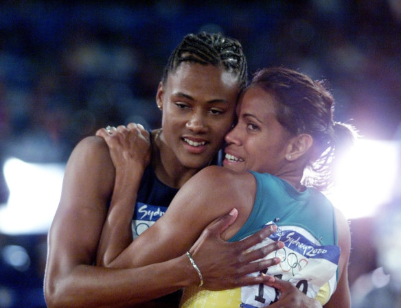 Marion Jones is congratulated by Cathy Freeman after winning the 200m final.