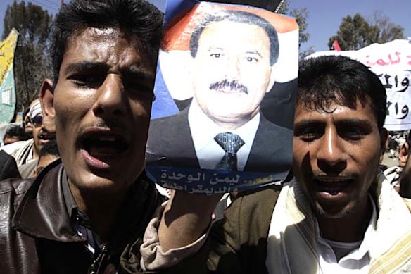 Yemen Government backers holding a picture of President Ali Abdullah Saleh shout slogans during a demonstration in Sanaa.