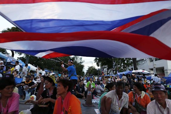 Anti-government protesters waves national flags.