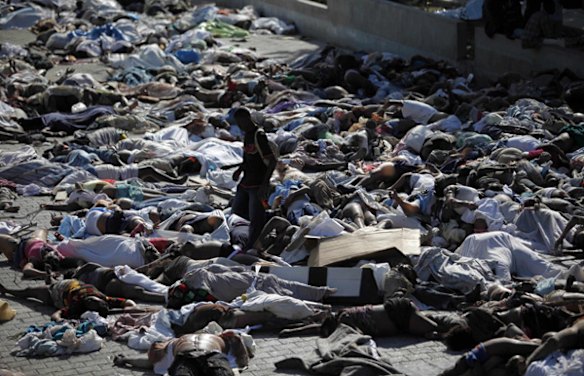 A man looks for a body among hundreds of earthquake victims at the morgue in Port-au-Prince.