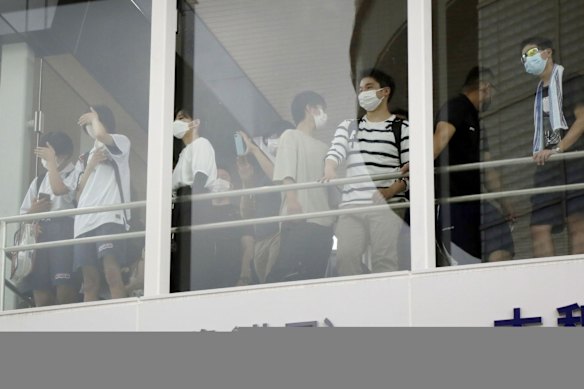 People look at the scene of the shooting.