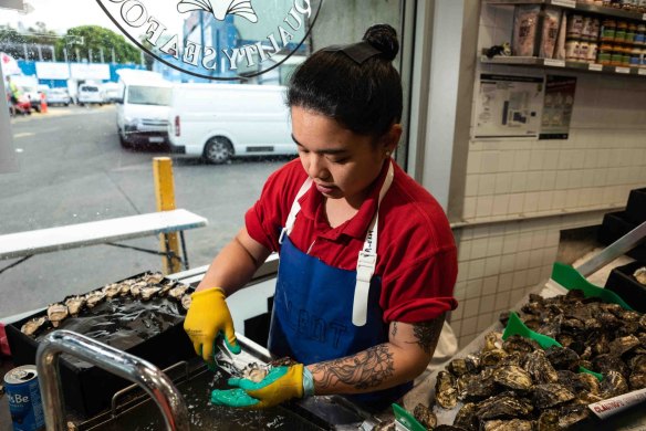 Shucking oysters at the Sydney Fish Market, in the lead up to Christmas.