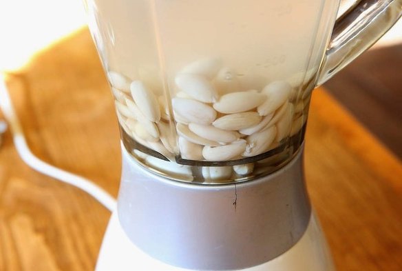 Step 3: Place almonds and two cups water and pinch of sea salt into a processor or blender.