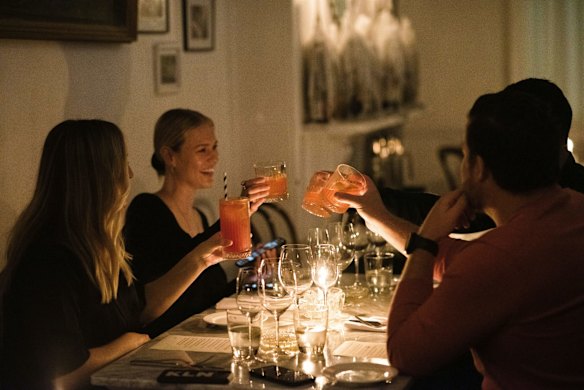 Restaurant goers toast each other on the first night of eased coronavirus lockdown conditions in Enmore.
