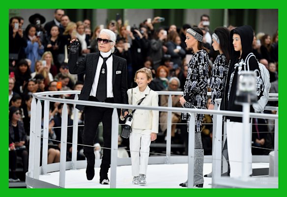 Designer Karl Lagerfeld and his godson Hudson Kroenig are seen on the runway during the finale of the Chanel show.