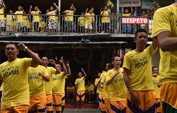 Inmates singing and dancing during an exercise routine inside Quezon City Jail, Manila, Philippines.