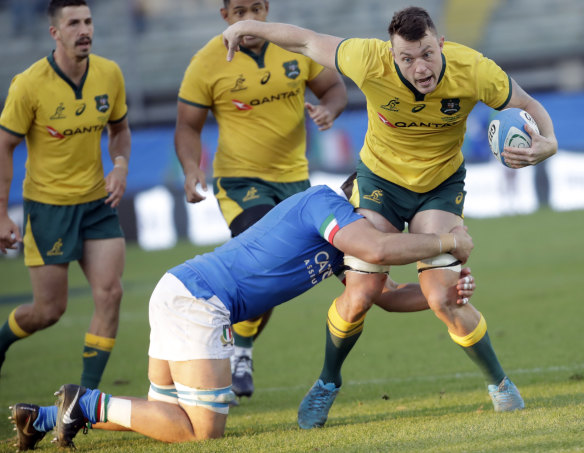 Australia's Jack Dempsey, right, is tackled by Italy's Jake Polledrid.