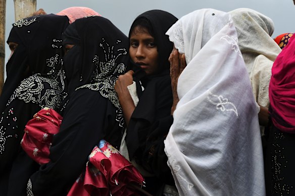 Rohingya women queue at a distribution site for non food items in the Kutupalong camp.