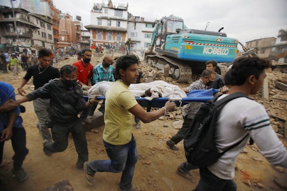 Volunteers carry the body of a victim on a stretcher, recovered from the debris of a building that collapsed after an earthquake  in Kathmandu, Nepal.