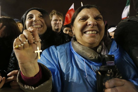 Crowds cheer after white smoke billowed from the chimney on the Sistine Chapel.