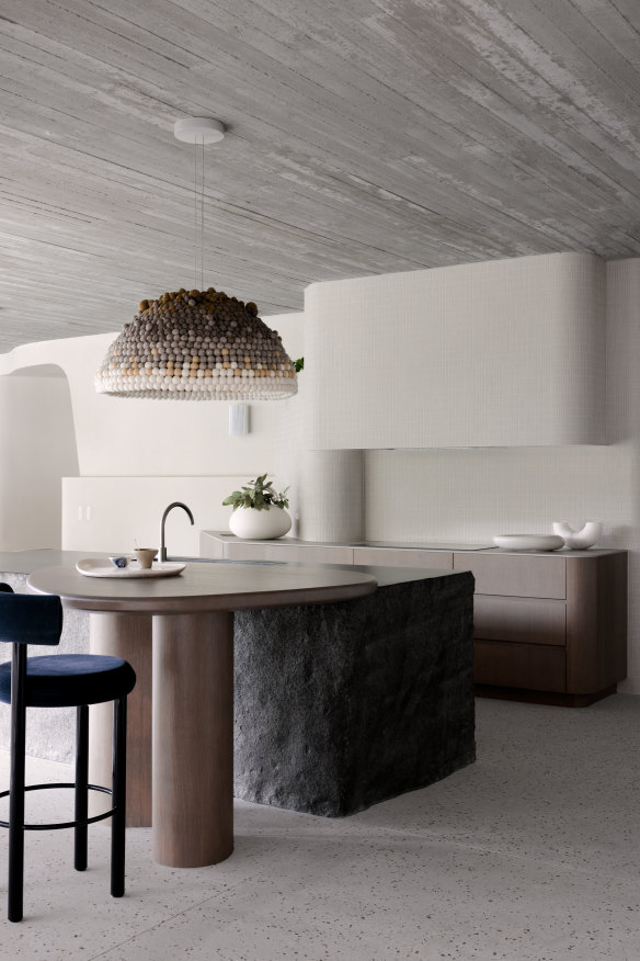 Custom lighting by local artist Susan Lincoln hovers over the granite stone bench brought up from South Australia.