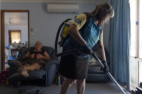 Booraja Home Care worker Narelle Welsh, vacuuming  Norman Russell's home in Broulee.