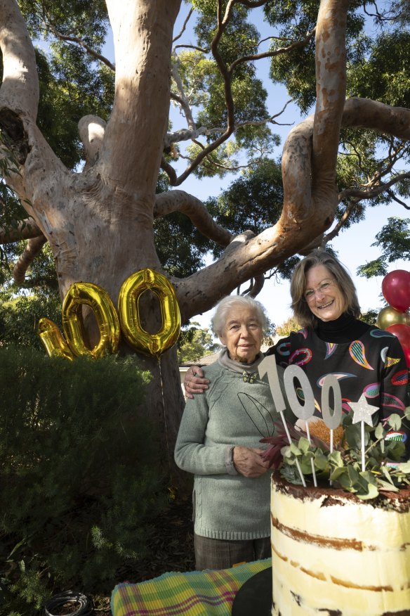 Kumari Pease (right) and Joan Couzoff  celebrate their favourite tree’s centenary.