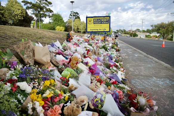 Flowers, toys and chalk messages lined the footpath along Lawrence Drive outside Hillcrest Primary School.