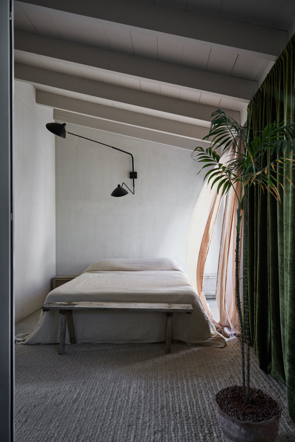 “We asked the builder to stop after the first stage of render on the bedroom walls, as it was beautiful in that raw state,” says Chard. The wall light is by Serge Mouille.